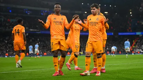 Brahim Diaz of Real Madrid celebrates scoring his team's second goal with Vinicius Junior during the UEFA Champions League 2024/25 League Knockout Play-off first leg match between Manchester City and Real Madrid C.F. at Manchester City Stadium on February 11, 2025 in Manchester, England.