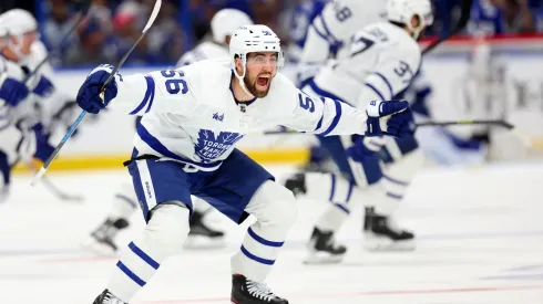 Erik Gustafsson #56 of the Toronto Maple Leafs celebrate winning Game Six of the First Round of the 2023 Stanley Cup Playoffs on an overtime goal by John Tavares #91 against the Tampa Bay Lightning.