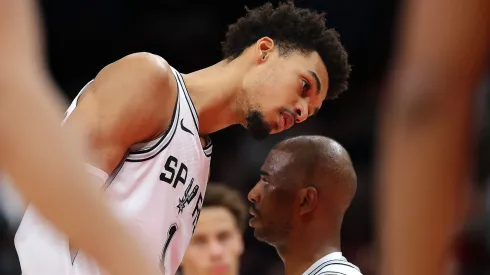 Spurs' Victor Wembanyama listens to Chris Paul during a game against the Atlanta Hawks on February 05, 2025.