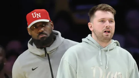 Luka Doncic #77 and LeBron James #23 of the Los Angeles Lakers look on during the fourth quarter of a game against the Indiana Pacers