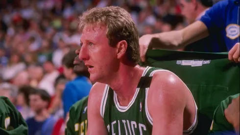 Forward Larry Bird of the Boston Celtics sits on the bench during a game.