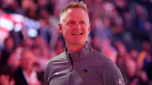 Golden State Warriors head coach Steve Kerr stands for the national anthem before their preseason game against the Sacramento Kings