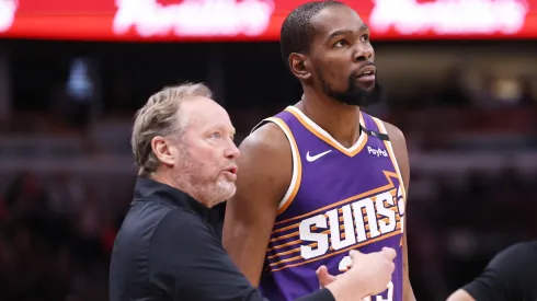 Kevin Durant #35 of the Phoenix Suns gets instructions from head coach Mike Budenholzer during the fourth quarter against the Chicago Bulls at the United Center on February 22, 2025 in Chicago, Illinois.