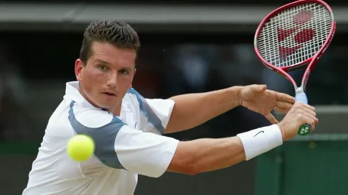 Richard Krajicek of the Netherlands in action against Xavier Malisse of Belgium during the mens quarter final match at 2002 Wimbledon.
