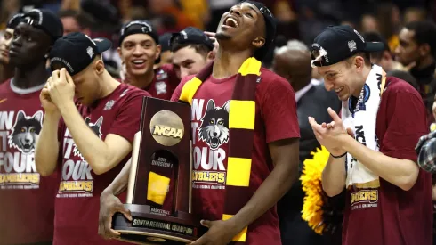 Donte Ingram #0 of the Loyola Ramblers celebrates with the trophy after defeating the Kansas State Wildcats during the 2018 NCAA Men's Basketball Tournament South Regional.