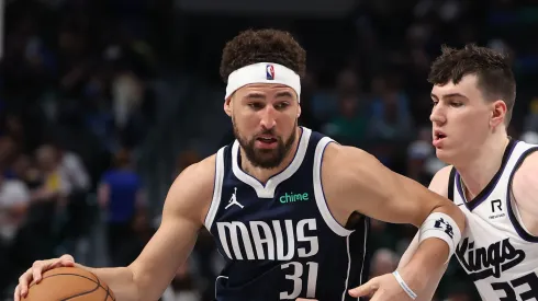 Klay Thompson #31 of the Dallas Mavericks brings the ball up court against Jake LaRavia #33 of the Sacramento Kings