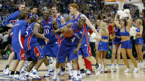 Sherron Collins #4 and the Kansas Jayhawks celebrate after defeating the Memphis Tigers 75-68 in overtime during the 2008 NCAA Men's National Championship game.