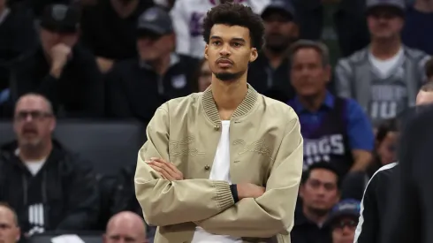 Injured Victor Wembanyama #1 of the San Antonio Spurs watches his team play against the Sacramento Kings during the second half at Golden 1 Center on March 07, 2025 in Sacramento, California.