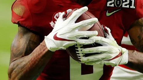 DeVonta Smith #6 of the Alabama Crimson Tide rushes ahead of Josh Proctor #41 of the Ohio State Buckeyes during the second quarter of the College Football Playoff National Championship game at Hard Rock Stadium on January 11, 2021 in Miami Gardens, Florida.