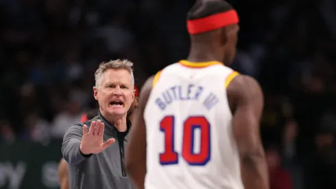 Head coach Steve Kerr of the Golden State Warriors talks to Jimmy Butler #10 during the third quarter against the Dallas Mavericks at American Airlines Center on February 12, 2025 in Dallas, Texas.