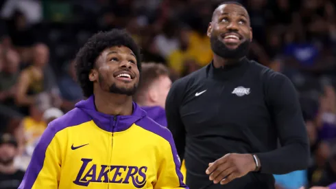 Bronny James #9 and LeBron James #23 of the Los Angeles Lakers look on during warm ups prior to the game against the Phoenix Suns at Acrisure Arena on October 06, 2024 in Palm Springs, California.