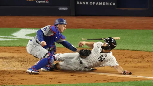 Will Smith #16 of the Los Angeles Dodgers tags out Giancarlo Stanton #27 of the New York Yankees in the fourth inning during Game Three of the 2024 World Series.