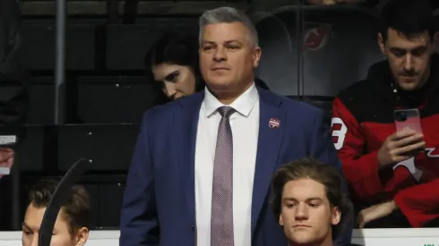New Jersey Devils head coach Sheldon Keefe prepares to tend to the bench prior to the game against the Boston Bruins at Prudential Center on January 22, 2025 in Newark, New Jersey.