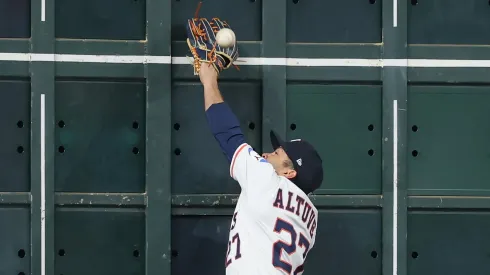 Jose Altuve #27 of the Houston Astros attempts to catch a ball hit by Juan Soto #22 of the New York Mets (not pictured) at the left field wall in the first inning at Daikin Park on March 29, 2025 in Houston, Texas.