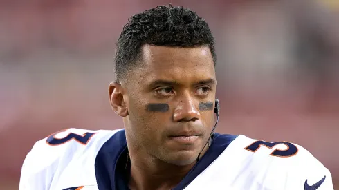 Russell Wilson looks on from the sidelines of a preseason game against the San Francisco 49ers during the fourth quarter at Levi's Stadium on August 19, 2023 in Santa Clara, California.