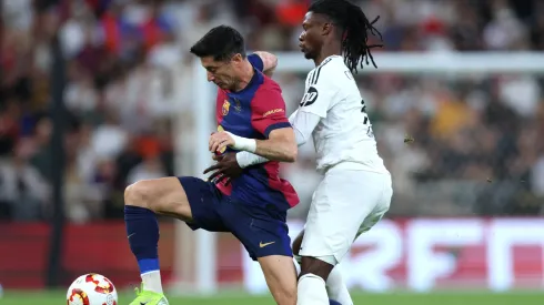 Robert Lewandowski of FC Barcelona is challenged by Eduardo Camavinga of Real Madrid during the Spanish Super Cup Final between Real Madrid and FC Barcelona
