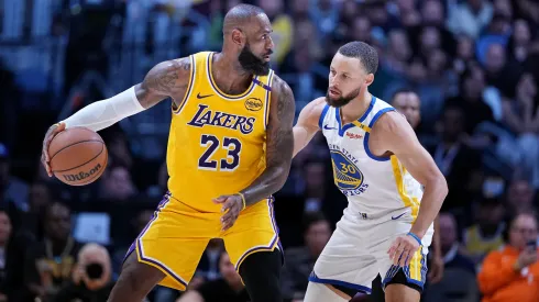 LeBron James #23 of the Los Angeles Lakers controls the ball against Stephen Curry #30 of the Golden State Warriors during the second half of a game at Crypto.com Arena on April 03, 2025 in Los Angeles, California.