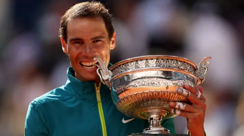 Rafael Nadal of Spain bites the trophy after winning against Casper Ruud of Norway the 2022 Roland Garros final.