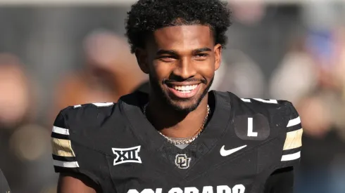 (L-R) Shilo Sanders #21, Head coach Deion Sanders and Shedeur Sanders #2 of the Colorado Buffaloes walk the field during senior day celebrations prior to the game against the Oklahoma State Cowboys at Folsom Field on November 29, 2024 in Boulder, Colorado.