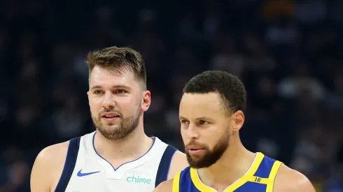 Stephen Curry #30 of the Golden State Warriors and Luka Doncic