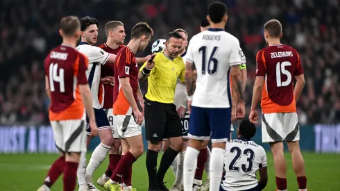 Referee Orel Grinfeeld reacts as Myles Lewis-Skelly of England goes down with an injury during the FIFA World Cup 2026 European Qualifier between England and Latvia in 2025.