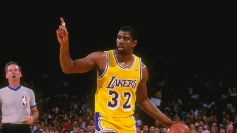 Point guard Magic Johnson of the Los Angeles Lakers dribbles the ball down the court during a game