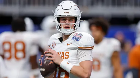 Arch Manning #16 of the Texas Longhorns warms up prior to the Chick-fil-A Peach Bowl between the Texas Longhorns and Arizona State Sun Devils at Mercedes-Benz Stadium on January 1, 2025 in Atlanta, Georgia.