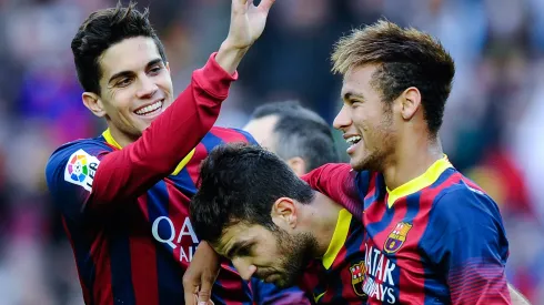 Cesc Fabregas (C) of FC Barcelona celebrates with his teammates Marc Bartra (L) and Neymar after scoring his team's second goal from the penalty spot during the La Liga match between FC Barcelona and Granda CF at Camp Nou on November 23, 2013 in Barcelona, Spain.