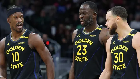 Jimmy Butler #10, Draymond Green #23 and Stephen Curry #30 of the Golden State Warriors walk backcourt during a game against the Milwaukee Bucks.