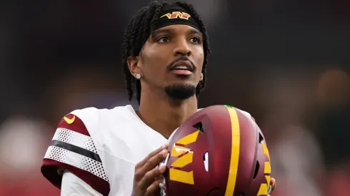 Jayden Daniels #5 of the Washington Commanders looks on during the second half against the Arizona Cardinals at State Farm Stadium on September 29, 2024 in Glendale, Arizona.