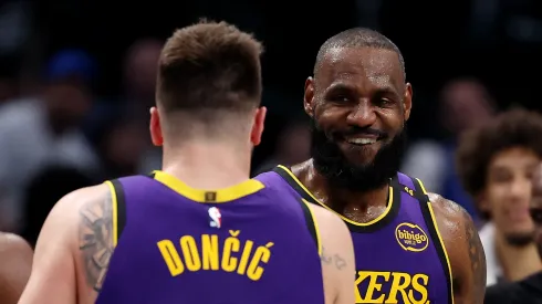 Luka Doncic #77 embraces LeBron James #23 of the Los Angeles Lakers during the fourth quarter against the Dallas Mavericks