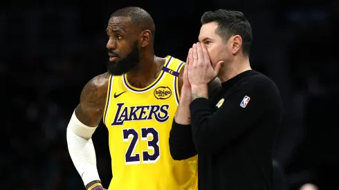Head coach JJ Redick and LeBron James #23 of the Los Angeles Lakers speak during the first half of the game against the Charlotte Hornets at Spectrum Center on January 27, 2025 in Charlotte, North Carolina.