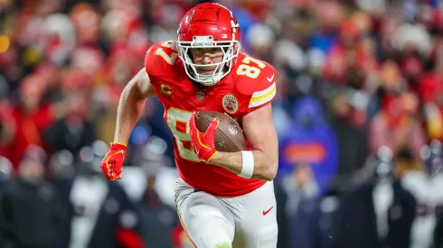 Travis Kelce #87 of the Kansas City Chiefs runs for yardage after a third quarter pass catch in the Divisional Round playoff at GEHA Field at Arrowhead Stadium on January 18, 2025.