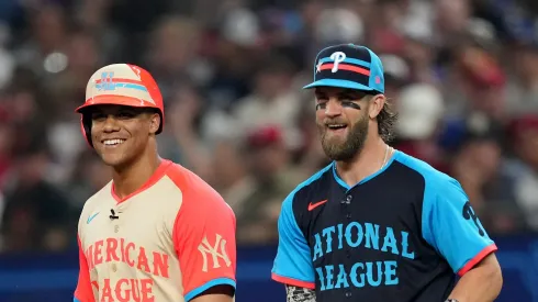 Former Yankees' Juan speaks with Bryce Harper #3 of the Philadelphia Phillies at first base during the 94th MLB All-Star Game presented by Mastercard at Globe Life Field on July 16, 2024 in Arlington, Texas.