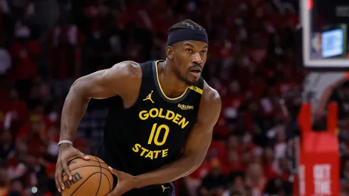 Jimmy Butler III #10 of the Golden State Warriors controls the ball against Amen Thompson #1 of the Houston Rockets