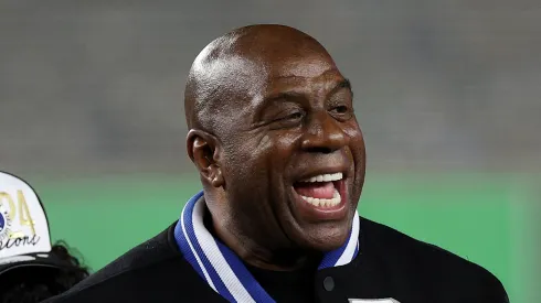 Magic Johnson celebrates with the Los Angeles Dodgers after the Dodgers defeated the New York Yankees 7-6 in game 5