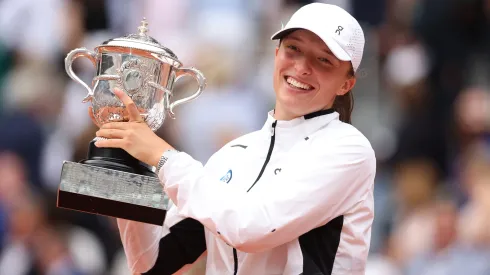 Iga Swiatek of Poland celebrates with her winners trophy after victory against Karolina Muchova of Czech Republic in the Women's Singles Final match on Day Fourteen of the 2023 French Open.