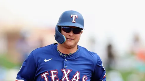 Joc Pederson #4 of the Texas Rangers rounds the bases after hitting a three-run home run against the Cincinnati Reds during the first inning of the MLB game at Surprise Stadium on March 12, 2025 in Surprise, Arizona.