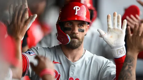 Bryce Harper #3 of the Philadelphia Phillies celebrates with teammates after hitting a two-run home run during the eighth inning against the Cleveland Guardians.