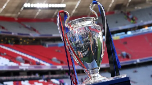 A detailed view of the UEFA Champions League trophy, which features ribbons in both teams colours, on the plinth prior to the UEFA Champions League Final 2025.