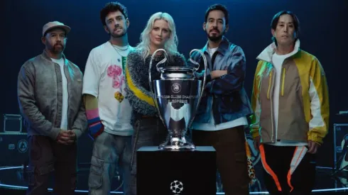 Colin Brittain, Emily Armstrong, Mike Shinoda and Joe Hahn of Linkin Park with the 2025 UEFA Champions League trophy.