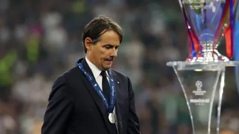 Simone Inzaghi, Head Coach of FC Internazionale, looks dejected as he walks past the UEFA Champions League trophy