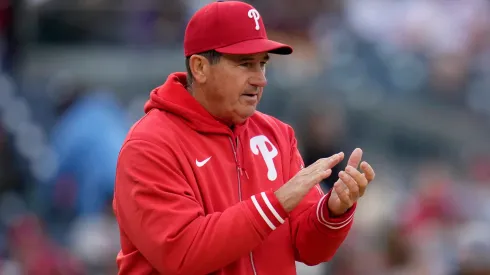 Rob Thomson #59 of the Philadelphia Phillies claps as he walks to the pitcher's mound during the eighth inning of a game against the Washington Nationals at Nationals Park on April 06, 2024 in Washington, DC.