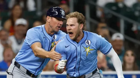 Taylor Walls #6 of the Tampa Bay Rays is held back by a coach after returning from the dugout after being ejected in the ninth inning against the Houston Astros at Daikin Park on June 01, 2025 in Houston, Texas.