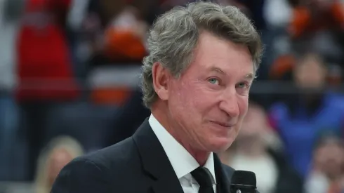 Wayne Gretzky speaks to the crowd and to Alex Ovechkin #8 of the Washington Capitals following his record-breaking 895th career goal.