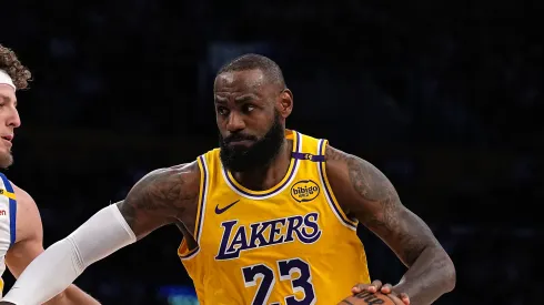 LeBron James #23 of the Los Angeles Lakers dribbles the ball during the first half of a game against Brandin Podziemski #2 of the Golden State Warriors
