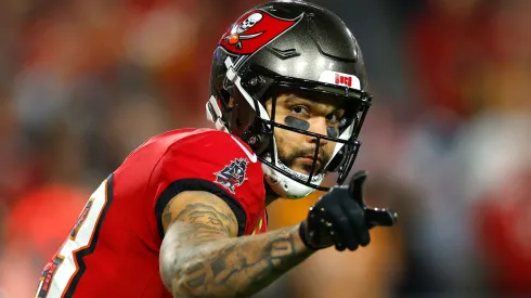 Mike Evans #13 of the Tampa Bay Buccaneers points against the Washington Commanders during the fourth quarter in the NFC Wild Card Playoff at Raymond James Stadium on January 12, 2025 in Tampa, Florida.