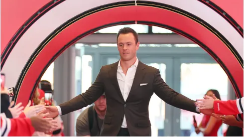 Jonathan Toews #19 of the Chicago Blackhawks high fives fans as he arrives to the red carpet prior to the game against the Detroit Red Wings at United Center on October 21, 2022 in Chicago, Illinois.