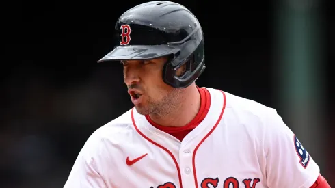 Alex Bregman #2 of the Boston Red Sox calls to the dugout for a trainer after hitting a single against the Baltimore Orioles during the fifth inning at Fenway Park on May 23, 2025 in Boston, Massachusetts.