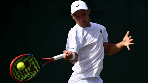 Kamil Majchrzak plays a forehand against Arthur Rinderknech during the third round match of The Championships Wimbledon 2025